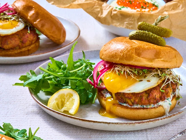 Crab Cake Brunchwich on a Plate with Lemon Wedge and Salad