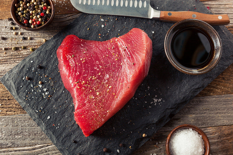 Ahi Tuna Steak on Black Slate with Peppercorns and Salt