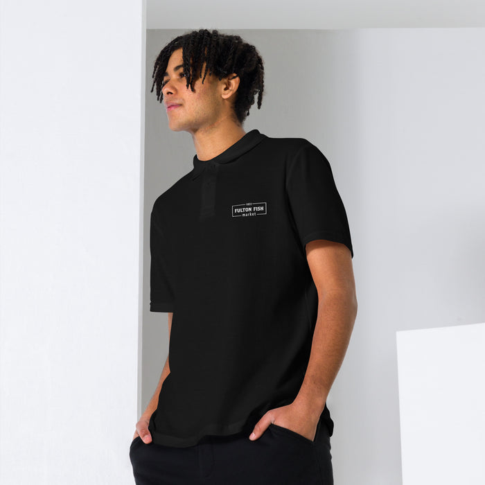 Male Model Wearing Black Polo Shirt with White Fulton Fish Market Logo