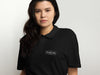 Female Model Wearing Black Polo Shirt with White Fulton Fish Market Logo