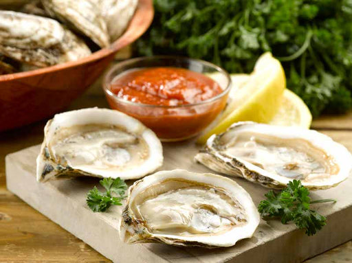 Shucked Blue Point Oysters with Sauce, Lemon Wedges and Parsley