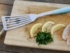 Toadfish Ultimate Spatula on Cutting Board with Lemons and Herbs