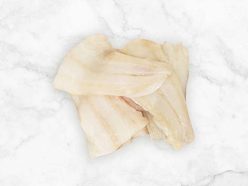 White Fish Tail Pieces on Marble Surface