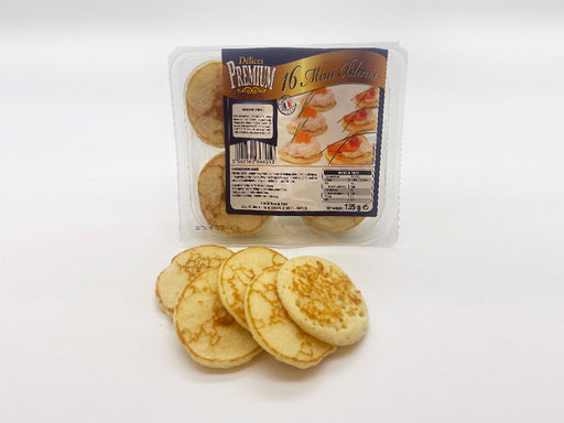 Blinis in Package on White Background with Few Blinis Out of Package in Front